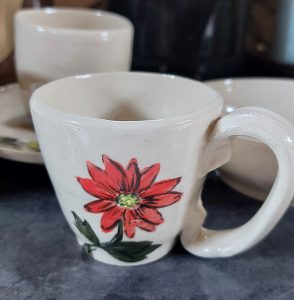White teacup with red flower design