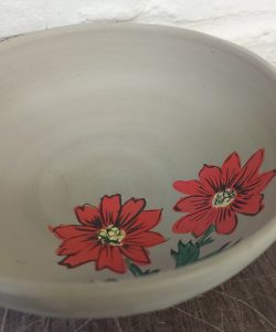 white bowl with red flower design