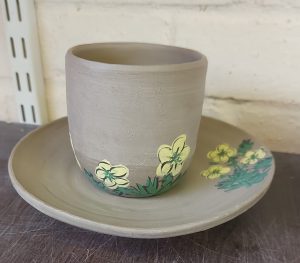 handpainted cup and saucer with yellow flower design