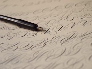 pen on paper with calligraphy writing
