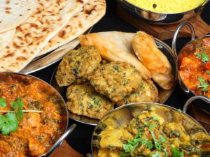 Four indian dishes and naan bread