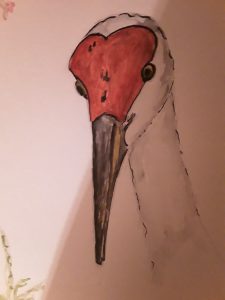 Painting of a crane with a red head