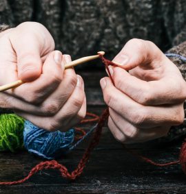 hands using wool to crochet with hook