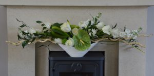 Floral arrangement with white flowers and green foliage