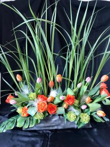 Floral arrangement with orange roses and tulips