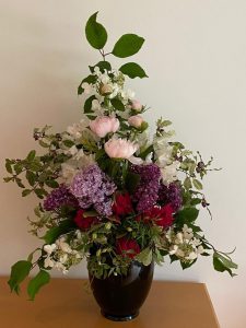 Pink, red and purple flower arrangement in vase