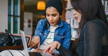 Two women working on laptop