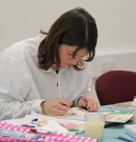 Woman in white shirt painting