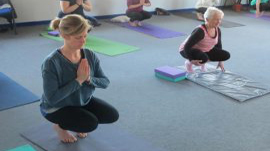 Two women practising yoga