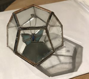 Glass and metal hexagon box with butterfly inside