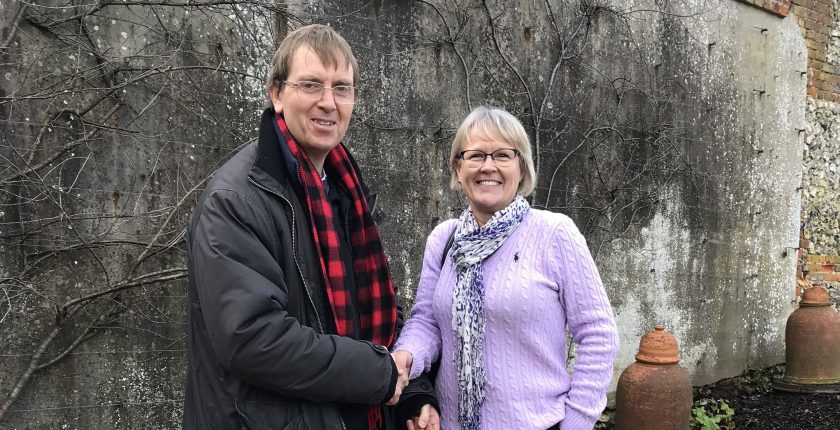 Man shaking hands with woman