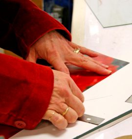 Woman cutting paper for a picture frame