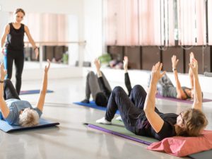 Group of women and tutor in pilates class