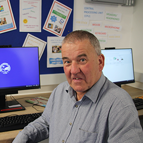 man in front of computer screen