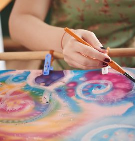 Woman painting on silk fabric