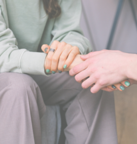 counsellor holding patients hand