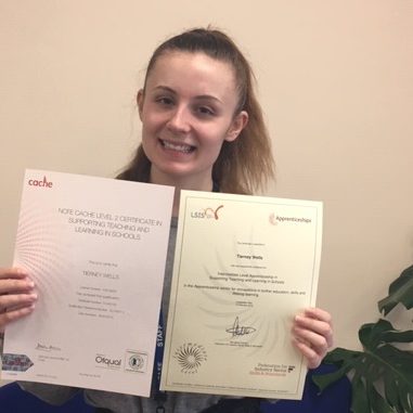 Young woman holding two certificates