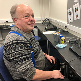 learner sitting at desk with laptop