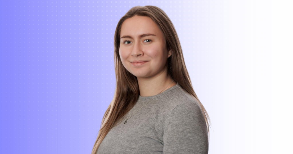 Person with long hair and a grey jump on a purple background