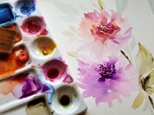 watercolour painting of purple and pink flowers with paint palette and paintbrushes