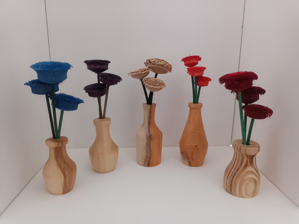 A row of 5 wooden vases