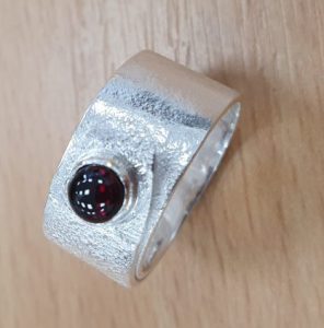 silver ring with red stone
