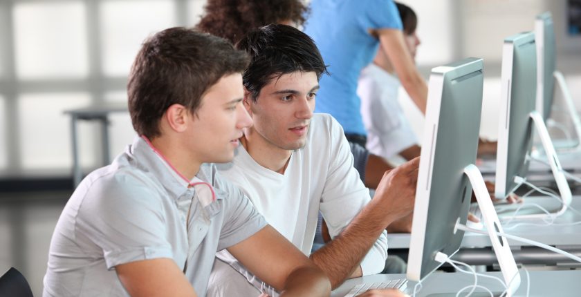 Two men looking at computer screen