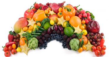 Fruit and vegetables laid out in rainbow shape