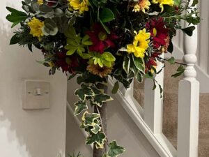 topiary tree with red and yellow flowers